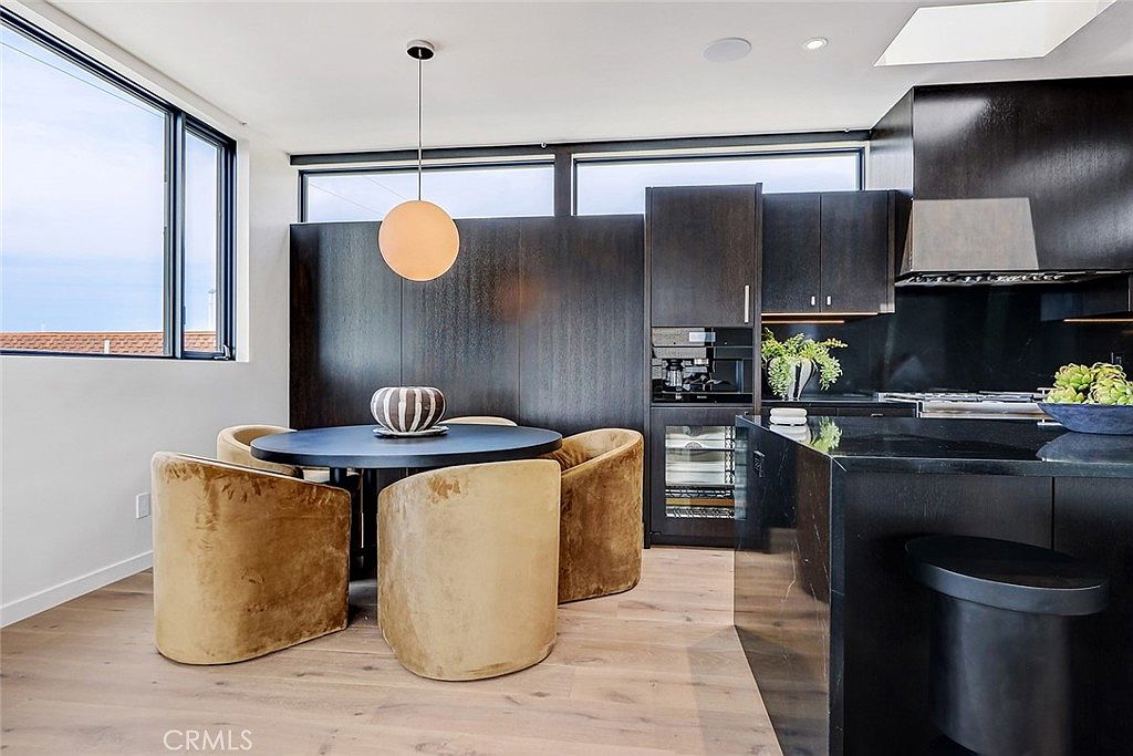 Dining and living area with floor to ceiling glass facing the patio